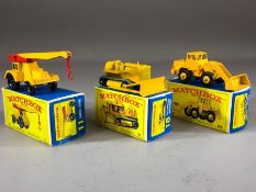 Three boxed Matchbox Series diecast model vehicles: 11 Jumbo Crane, 18 Caterpillar Bulldozer, 69