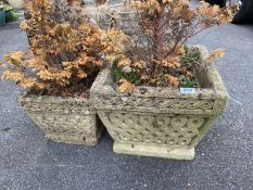 Two similar concrete garden planters