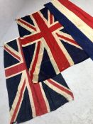 Two vintage Union Jack flags, the larger approx 205cm x 115cm, along with a further piece of red.