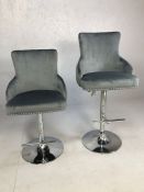 Pair of kitchen island bar stools on chrome bases with grey leather upholstery, fully adjustable