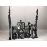 Collection of carved wooden tribal items to include masks and a set of three graduating birds (8)