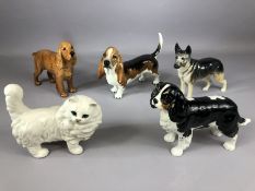 Collection of four Beswick dogs (King Charles Spaniel, Ulrica of Brittas, Basset Hound and Cocker