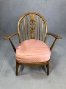 Mid Century low armchair in an Arts and Crafts style, with sprung seat