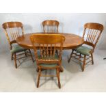 Circular extending dining table with four carved country-style dining chairs, table approx 107cm