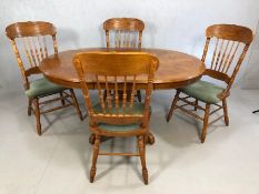 Circular extending dining table with four carved country-style dining chairs, table approx 107cm