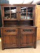 Oak dresser with two drawers, two cupboards below, glazed shelves above, approx 140cm x 47cm x 178cm