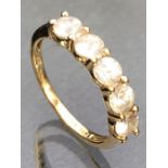 9ct Gold ring set with five gemstones of pale blue appearance each in four claw settings, ring