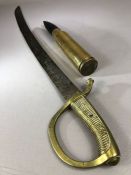 Militaria: Cutlass or sword with brass handle and a shell casing