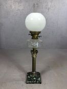 Large oil lamp on stepped marble plinth, with brass Corinthian column supporting etched clear