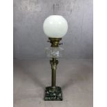 Large oil lamp on stepped marble plinth, with brass Corinthian column supporting etched clear