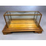 Glass display case on wooden base with carved rope twist detailing, base approx 70cm x 32cm x 18cm