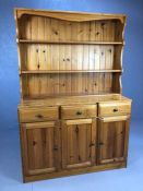 Pine kitchen dresser with shelves over and cupboards and drawers under, approx 119cm x 46cm x