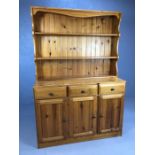 Pine kitchen dresser with shelves over and cupboards and drawers under, approx 119cm x 46cm x