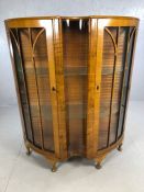 Art Deco serpentine fronted display cabinet with two doors, two glass shelves and curved glass