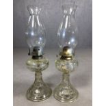 Pair of clear glass oil lamps, approx 47cm tall