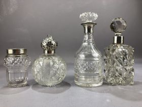 Collection of four cut glass and silver hallmarked collared bottles the tallest approx 18cm