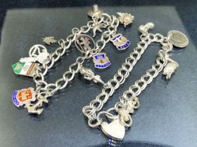 Two Hallmarked Silver charm bracelets with various charms