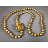 Bone necklace of carved beads with a carved Panda and bamboo approx 60cm long