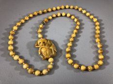 Bone necklace of carved beads with a carved Panda and bamboo approx 60cm long