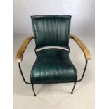 Single blue leather upholstered retro style chair on black metal frame with wooden arms