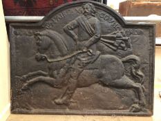 Cast iron fire back depicting a man riding a horse, approx 85cm x 67cm