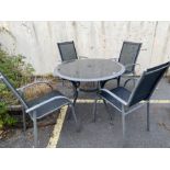 Glass and aluminium circular garden table and four chairs