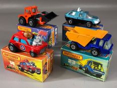 Four boxed Matchbox Superfast diecast model vehicles: 14 Mini-Ha-Ha, 23 Atlas, 29 Tractor Shovel, 59