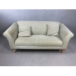 Two seater grey fabric sofa on turned pine legs with two matching cushions, approx 177cm x 83cm x