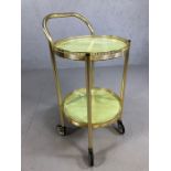 Vintage gold coloured circular tea trolley on wheels