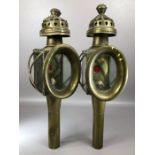 Pair of Brass Coaching Oil lamps with red glass to reverse and ornate chimneys approx 45cm tall