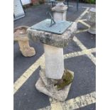 Concrete garden sundial with metal sundial