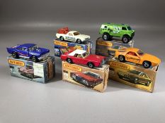 Five boxed Matchbox diecast model vehicles: 4 '57 Chevy, Superfast 28 Lincoln Chevy, 59 Porsche 928,