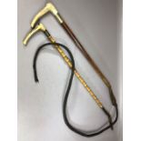 Two vintage riding crops one with Silver hallmarked collar and both with horn handles