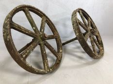Pair of seven spoke vintage cast iron cartwheels with axels, approx 75cm in diameter