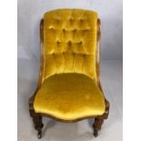 Antique bedroom chair in mustard fabric with button back on original castors, stands approx 85cm