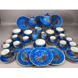 Extensive Japanese early 20th century porcelain tea set with dragon decoration, the cups with a