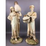 Pair of Royal Worcester Cairo Water Carrier Figures, in floral bordered robes, raised on shaped