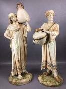 Pair of Royal Worcester Cairo Water Carrier Figures, in floral bordered robes, raised on shaped