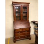 Modern bureau bookcase with fall front opening to pigeon holes and secret compartments, glazed