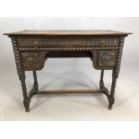 Heavily carved oak ladies writing desk on bobbin turned legs and stretcher, with three drawers,