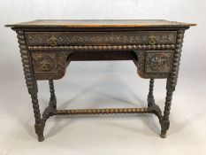 Heavily carved oak ladies writing desk on bobbin turned legs and stretcher, with three drawers,
