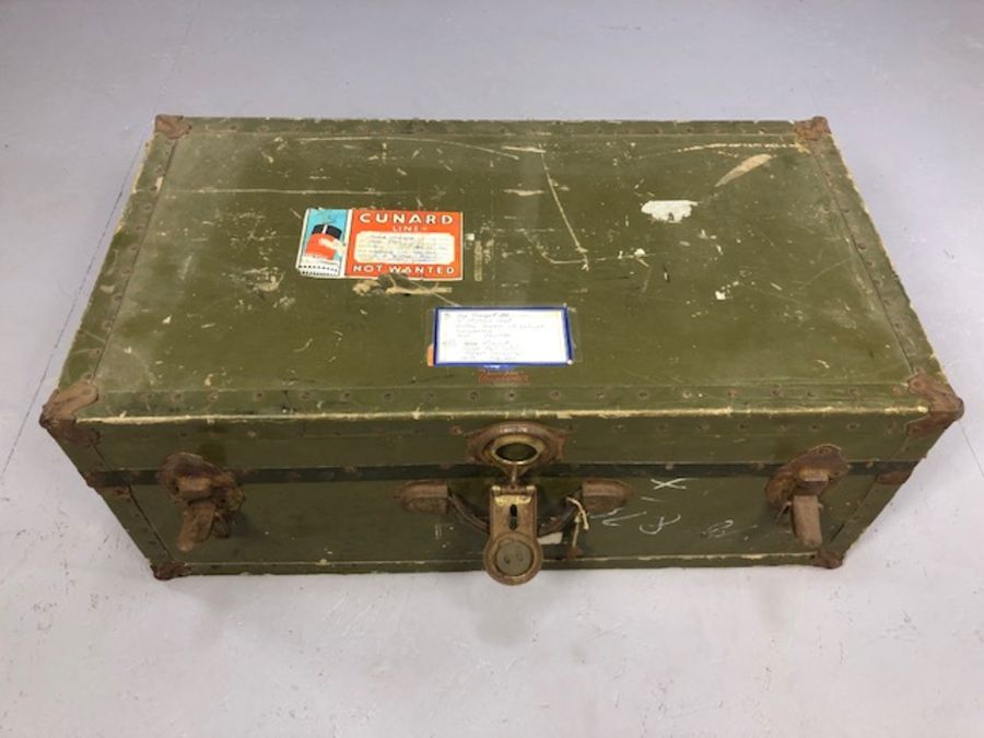 Vintage metal bound travel trunk with Cunard Line stickers for the Queen Mary, accompanied by