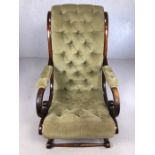 Antique x-frame large armchair with turned cross-stretchers and green button back upholstery, approx