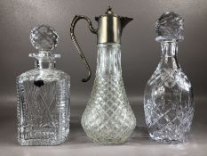 Two cut glass decanters and a cut glass claret jug with pewter lid, the tallest approx 29cm in