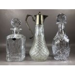 Two cut glass decanters and a cut glass claret jug with pewter lid, the tallest approx 29cm in