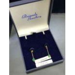 Pair of 9ct Gold drop earrings set with Emeralds each approx 25mm in length