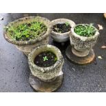 Collection of four raised concrete garden pots