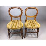 Pair of Victorian balloon back chairs with fabric floral seats, turned stretcher and outsplayed