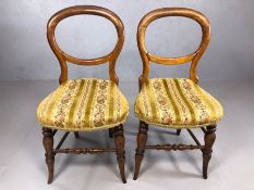 Pair of Victorian balloon back chairs with fabric floral seats, turned stretcher and outsplayed