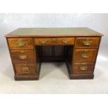 Twin pedestal leather-topped writing desk with brass fitments, approx 132cm x 61cm 77cm tall